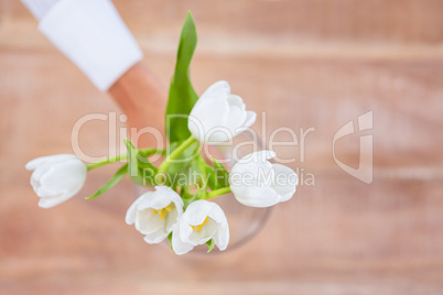 Woman putting a flowers in a vase