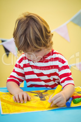 Small boy colouring in his picture