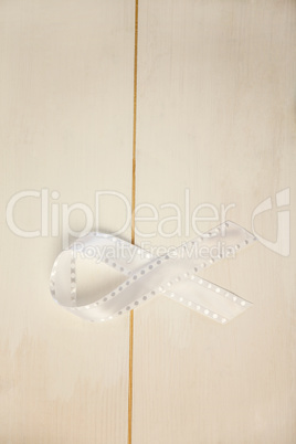 White ribbon on wooden desk