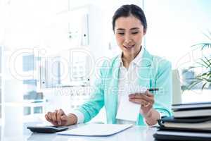 Focused businesswoman working hard with credit card