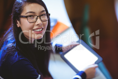 Student in lecture hall using tablet