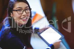 Student in lecture hall using tablet