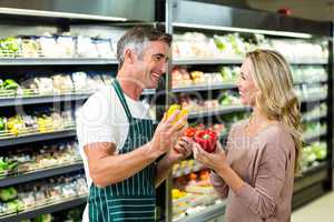 Smiling blonde woman buying a vegetables