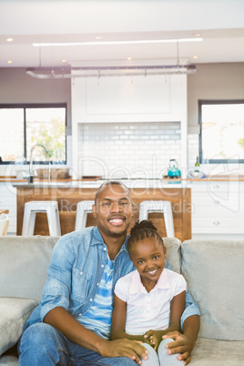 Casual father and daughter smiling at camera