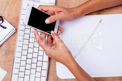 Businesswoman holding her smartphone