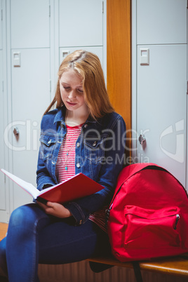 Focused student sitting and studying on notebook