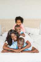 Family having fun together in bed