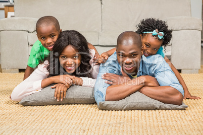 Happy family lying on the floor at home