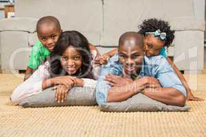 Happy family lying on the floor at home