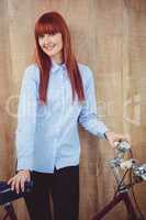 Smiling hipster woman with her bicycle