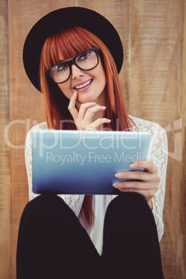 Smiling hipster woman using her tablet