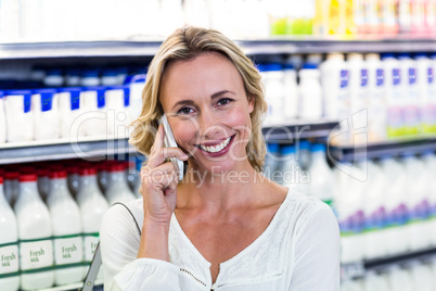 Smiling blonde woman having a call phone Smiling blonde woman having a call phone
