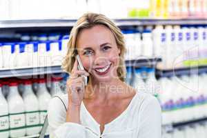 Smiling blonde woman having a call phone