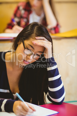 Thoughtful student studying on notebook