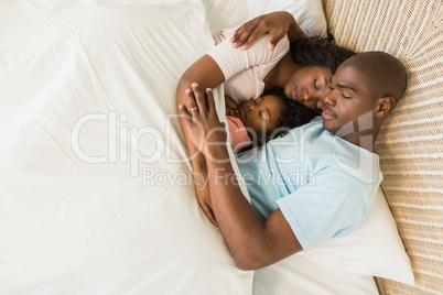 Pretty couple with daughter sleeping together