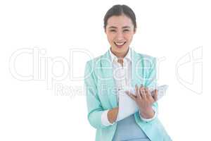 Smiling businesswoman holding notes