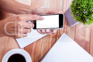 Overhead of feminine hands using smartphone