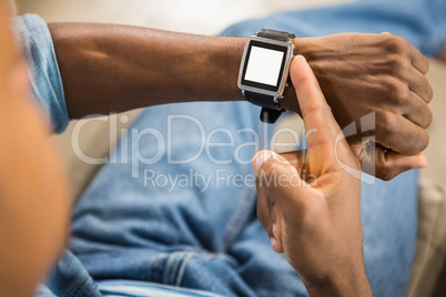 Close up view of a casual man using smart watch