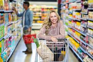 Young smiling mother doing shopping