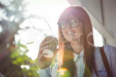 Smiing woman holding a cup of coffee