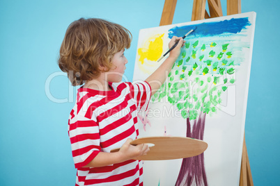 Happy boy painting his picture