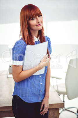 Smiling hipster woman holding document