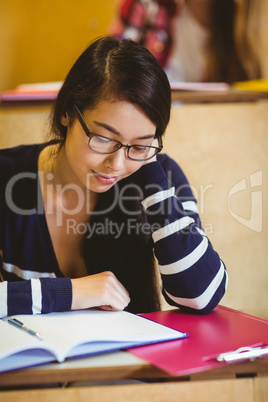 Focused student reading on notebook