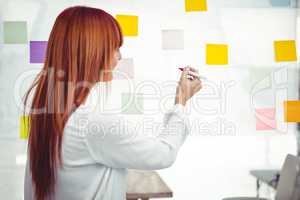 Attractive hipster woman writing on sticky notes