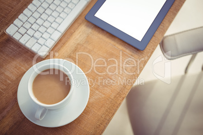 Business desk with coffee cup and tablet