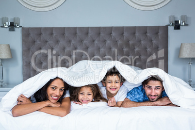 Happy family under the blanket