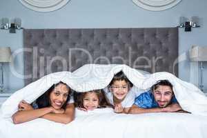 Happy family under the blanket
