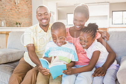 Happy family reading a book together