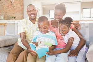Happy family reading a book together