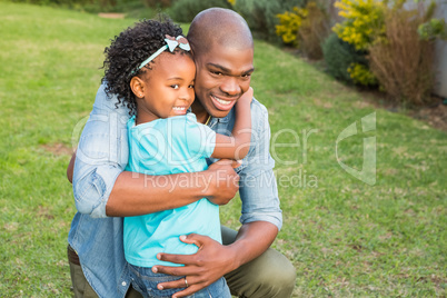 Smiling father hugging his daughter