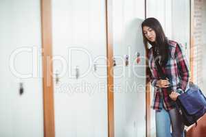 Restless student standing next the locker