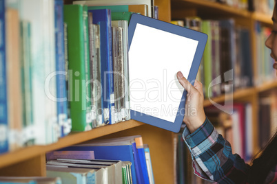 Pretty student putting table in bookshelf