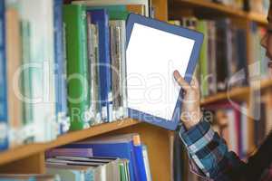 Pretty student putting table in bookshelf