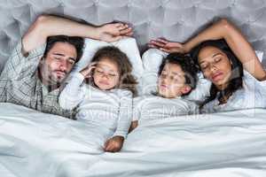 Happy family sleeping together