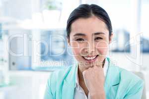 Smiling businesswoman with notes at desk