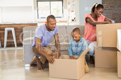 Family unwrapping things in new home