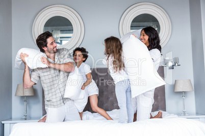 Happy family pillow fighting