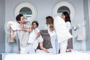 Happy family pillow fighting