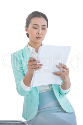 Smiling businesswoman using her notes