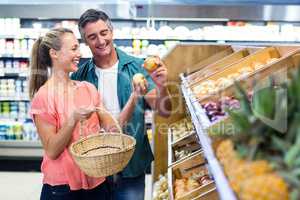 Happy couple holding potatoes