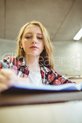 Focused student taking notes during class