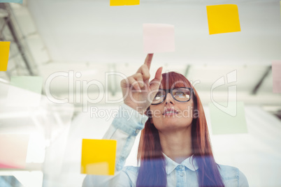 Attractive hipster woman pointing sticky notes