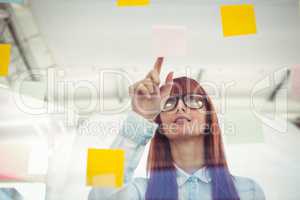 Attractive hipster woman pointing sticky notes