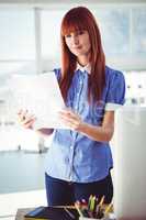 Attractive hipster woman holding document