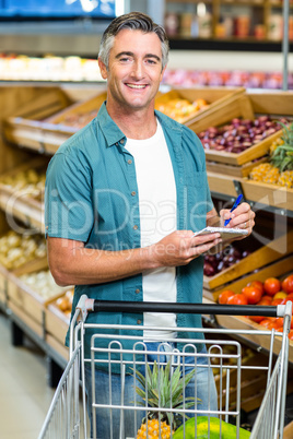 Smiling man looking at his list
