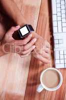 Feminine hands with smartwatch and coffee